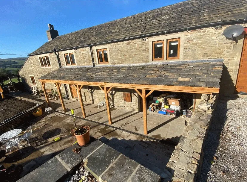 A stone building with a wooden roof.