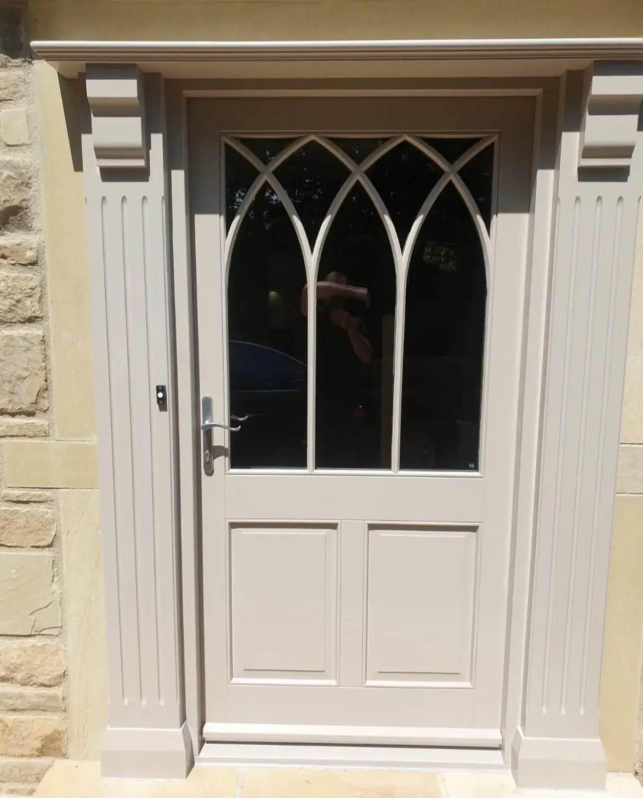 A close up of a door with a glass pane.